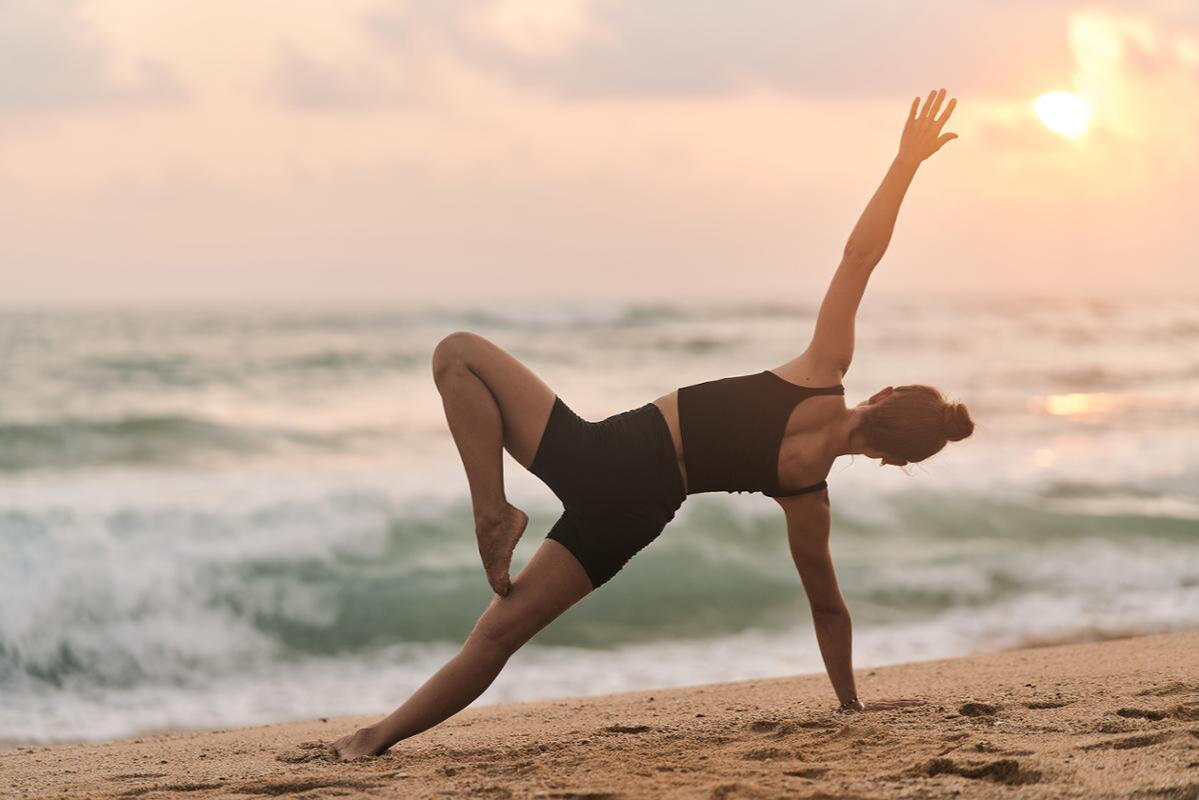 woman stretching on beach